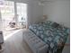 Comfortable bedroom featuring bright interiors, stylish bedding, and access to a private balcony at 1 Quails Run Blvd # 2, Englewood, FL 34223