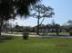 Peaceful view of the community featuring green lawns, trees and manicured bushes at 1 Quails Run Blvd # 2, Englewood, FL 34223