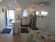 Modern kitchen featuring stainless steel appliances, sleek white cabinetry, and a central island with seating at 1 Quails Run Blvd # 2, Englewood, FL 34223