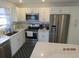 Bright kitchen featuring stainless steel appliances, white cabinetry, and an island for casual dining at 1 Quails Run Blvd # 2, Englewood, FL 34223