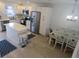 Modern kitchen boasting stainless steel appliances, white cabinetry, and a central island with seating at 1 Quails Run Blvd # 2, Englewood, FL 34223