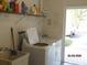 A well-lit laundry space featuring a washer and dryer, and extra storage space at 1 Quails Run Blvd # 2, Englewood, FL 34223