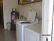 Bright laundry area with washer, dryer and extra storage space at 1 Quails Run Blvd # 2, Englewood, FL 34223
