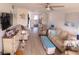 Open-concept living room featuring comfortable seating, a TV, and easy access to the kitchen and dining area at 1 Quails Run Blvd # 2, Englewood, FL 34223