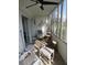 Bright sunroom with tiled floors featuring a ceiling fan, comfortable seating, and great natural light at 1 Quails Run Blvd # 2, Englewood, FL 34223