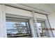 Exterior view of window with white hurricane shutters at 1 Quails Run Blvd # 2, Englewood, FL 34223