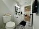 Modern bathroom features patterned floor tiles, white vanity and black accents at 10118 66Th Ave, Seminole, FL 33772