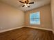 Bright bedroom features a ceiling fan, wood-look floors, and a window bringing in natural light at 10118 66Th Ave, Seminole, FL 33772