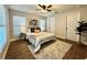 Well-lit bedroom with hardwood floors, a ceiling fan, and a neutral color palette at 10118 66Th Ave, Seminole, FL 33772