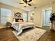 Bright bedroom featuring hardwood floors, a ceiling fan, and ensuite bathroom access at 10118 66Th Ave, Seminole, FL 33772