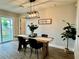 Cozy dining room with rustic table, modern light fixture, and natural light at 10118 66Th Ave, Seminole, FL 33772