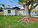 Lovely single-Gathering home with lush green grass and a mature tree in the front yard at 10118 66Th Ave, Seminole, FL 33772