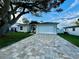 Inviting single-Gathering home with a brick driveway leading to the attached garage at 10118 66Th Ave, Seminole, FL 33772