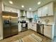 Updated kitchen featuring stainless steel appliances, white cabinets, and hardwood floors at 10118 66Th Ave, Seminole, FL 33772