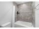 Well-lit bathroom with a shower/bathtub combo, neutral tile, and updated fixtures creating a clean and functional space at 1034 Grantham Dr, Sarasota, FL 34234