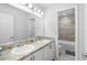 Bathroom with a double sink vanity, a large mirror and a shower/bathtub combo for convenience and style at 1034 Grantham Dr, Sarasota, FL 34234