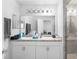 Bathroom featuring a double sink vanity, a large mirror and a glass-enclosed shower for a spa-like experience at 1034 Grantham Dr, Sarasota, FL 34234