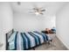 Cozy carpeted bedroom featuring a ceiling fan, neutral decor, and plenty of natural light, ideal for relaxation at 1034 Grantham Dr, Sarasota, FL 34234