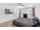 Spacious carpeted bedroom featuring a ceiling fan, tv, and natural light from two windows creating a cozy space at 1034 Grantham Dr, Sarasota, FL 34234
