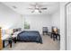 Comfortable carpeted bedroom featuring a ceiling fan, a tv, and a window for natural light and added comfort at 1034 Grantham Dr, Sarasota, FL 34234