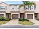Inviting exterior view of townhomes, showcasing dark shutters and a lush, landscaped lawn at 1034 Grantham Dr, Sarasota, FL 34234
