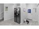 Hallway area near kitchen, featuring a stainless steel refrigerator and a neutral color palette at 1034 Grantham Dr, Sarasota, FL 34234