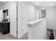 Bright hallway featuring carpet floors, white doors and trim, with access to various rooms throughout the home at 1034 Grantham Dr, Sarasota, FL 34234