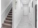 Bright hallway featuring modern tile flooring, clean white walls, and a staircase on the left at 1034 Grantham Dr, Sarasota, FL 34234