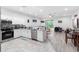 Open-concept kitchen featuring modern stainless steel appliances, white cabinets, and ample counter space at 1034 Grantham Dr, Sarasota, FL 34234