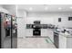 Well-lit kitchen with white cabinets, stainless steel appliances, and plenty of counter space at 1034 Grantham Dr, Sarasota, FL 34234