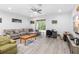 Spacious living room with hardwood floors, modern decor, and natural light from the sliding glass door at 1034 Grantham Dr, Sarasota, FL 34234