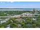 An aerial view captures the property's location near a bustling highway, surrounded by lush greenery and cityscapes at 1118 S Moody Ave, Tampa, FL 33629