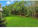 A well-maintained lawn with mature landscaping surrounds this beautiful backyard, creating a private and serene setting at 1118 S Moody Ave, Tampa, FL 33629