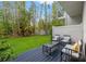 A wooden deck features outdoor seating in this backyard space with a small, well-maintained lawn and bamboo at 1118 S Moody Ave, Tampa, FL 33629
