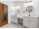 Bathroom boasts dual sinks, granite countertops, and modern lighting fixtures at 1118 S Moody Ave, Tampa, FL 33629