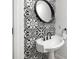 Powder bathroom features black and white patterned tile and decorative mirror at 1118 S Moody Ave, Tampa, FL 33629