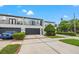 Three-story townhome boasts attached garages, first-floor entrances, and second-floor balconies with manicured landscaping at 1118 S Moody Ave, Tampa, FL 33629