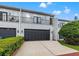 Inviting townhome featuring a private balcony, two-car garage and a meticulously maintained landscape at 1118 S Moody Ave, Tampa, FL 33629