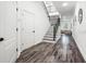 Spacious foyer featuring hardwood floors, a staircase with iron railings, and modern lighting at 1118 S Moody Ave, Tampa, FL 33629