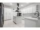 Bright modern kitchen featuring stainless steel appliances, an island, and ample counter space at 1118 S Moody Ave, Tampa, FL 33629