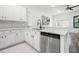 Bright kitchen with stainless steel dishwasher, white cabinets and eat in breakfast area at 1118 S Moody Ave, Tampa, FL 33629