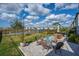 This backyard features a brick paver patio with seating and dining with a lake view at 12515 Horseshoe Bend Dr, Lithia, FL 33547