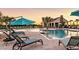 Inviting community pool with lounge chairs, umbrellas, and clubhouse in the background at 12515 Horseshoe Bend Dr, Lithia, FL 33547