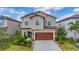 Charming two-story home with a beautiful front yard, stone accents, and a two-car garage at 12515 Horseshoe Bend Dr, Lithia, FL 33547