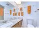 Bathroom features a granite countertop, lots of towels, and a large mirror at 1655 S Highland Ave # B110, Clearwater, FL 33756