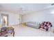 Open living room with ceiling fan, tile floors, and comfortable seating arrangement at 1655 S Highland Ave # B110, Clearwater, FL 33756