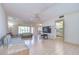 Expansive living room with tile flooring, neutral walls, and easy access to the dining area and kitchen at 1655 S Highland Ave # B110, Clearwater, FL 33756