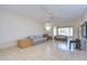 Spacious living room with tile flooring, ceiling fan, and abundant natural light at 1655 S Highland Ave # B110, Clearwater, FL 33756