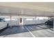 Covered parking with white fences, lights, and guest parking spots at 1655 S Highland Ave # B110, Clearwater, FL 33756