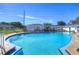 Large community pool with a spacious deck, seating and white fencing at 1655 S Highland Ave # B110, Clearwater, FL 33756